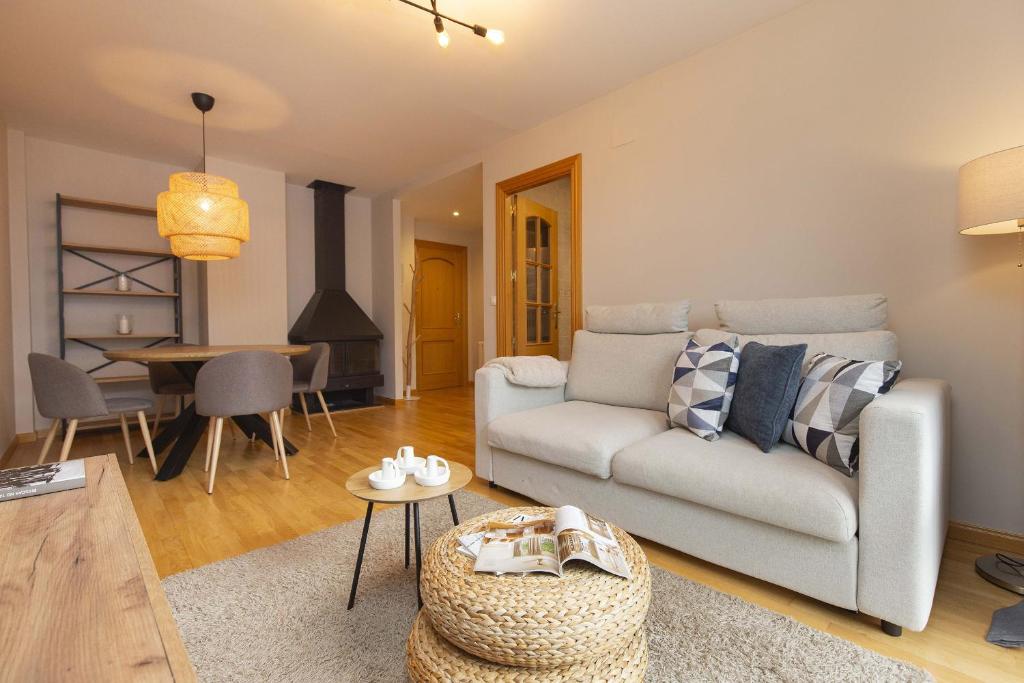 a living room with a couch and a table at Casa Lluna by BeValle in El Pueyo de Jaca