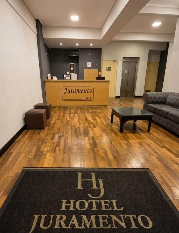 an office with a hotel hurricane sign on a rug at Hotel Juramento in Buenos Aires