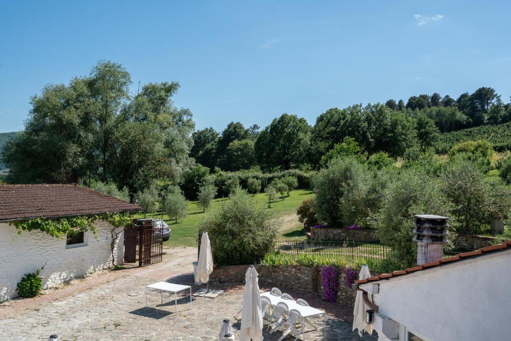 a view of a garden with chairs and a building at La Campana d'Oro Bibbiena in Bibbiena