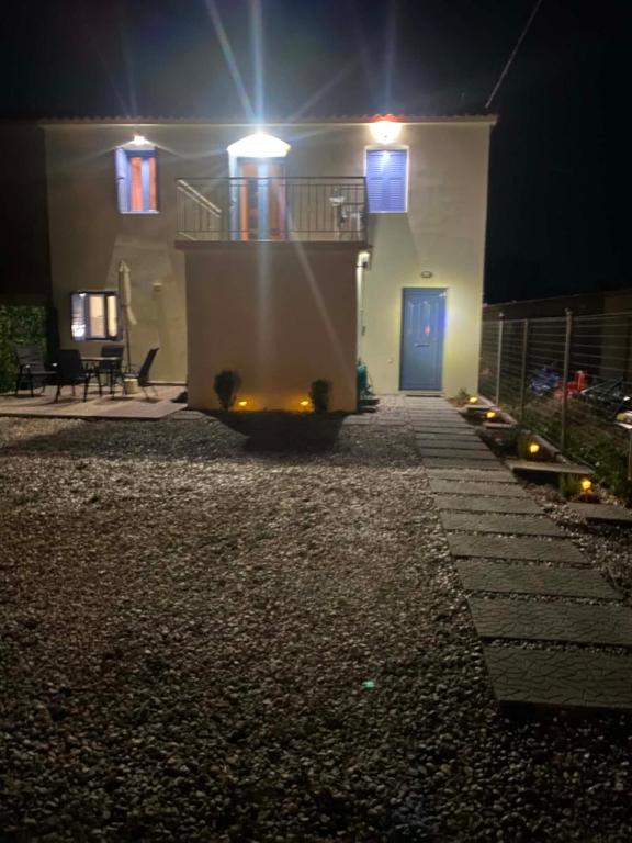 a house at night with a house with a blue door at Mary's home in Atsikí