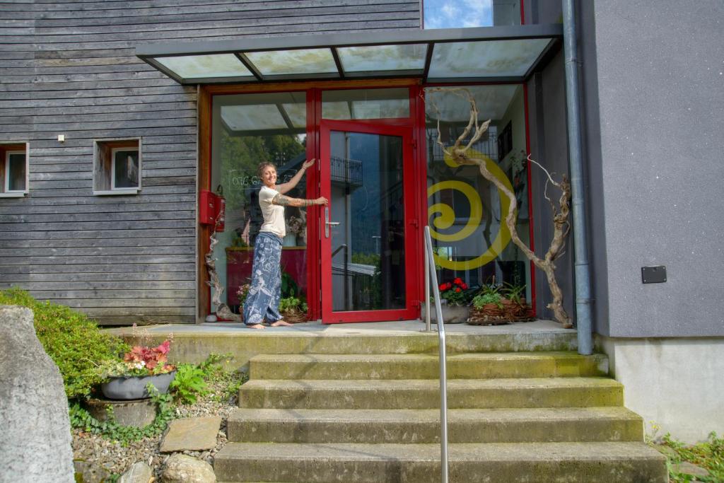a person standing in the doorway of a house at Ostello Cresciano in Cresciano