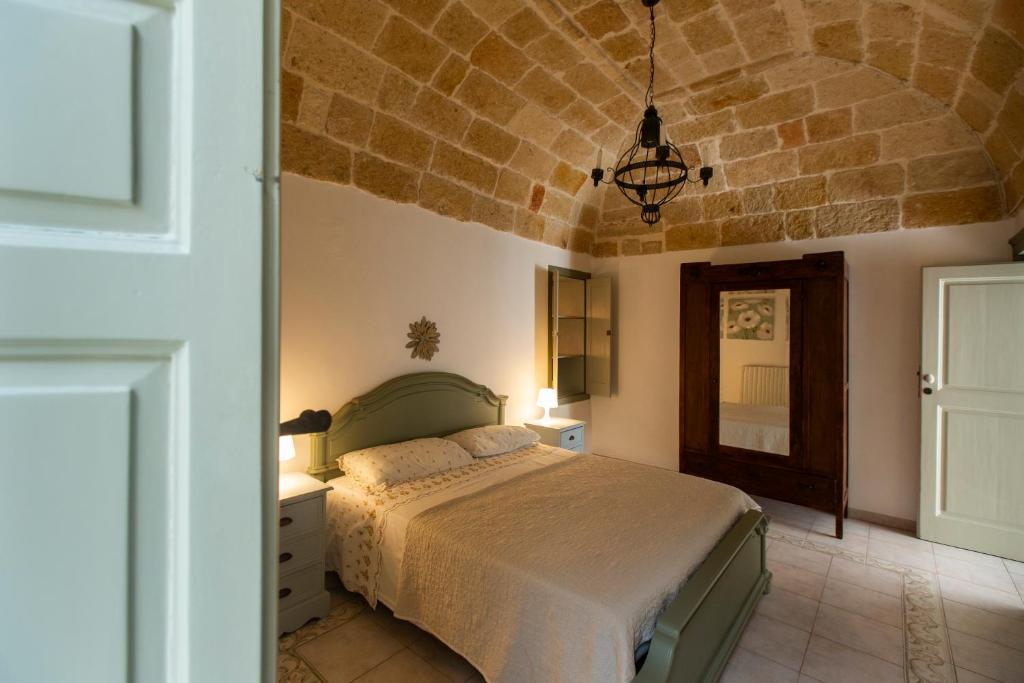 a bedroom with a bed and a brick wall at Nel Blu Dipinto di Blu - Casa Anemone in Polignano a Mare