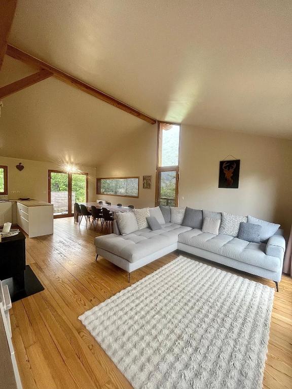 a living room with a couch and a table at Chalet 6 personnes ou studio 2 personnes in Ax-les-Thermes