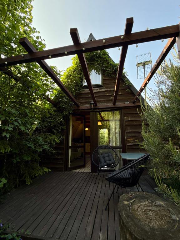 a wooden deck with a table and chairs on it at Domki Brzozowy Zakątek in Sochy