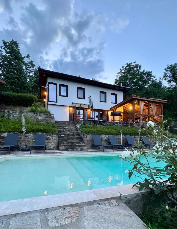 a house with a swimming pool in front of it at Vista Verde - Private house with 3 bedrooms & 3 bathrooms in Oreshak