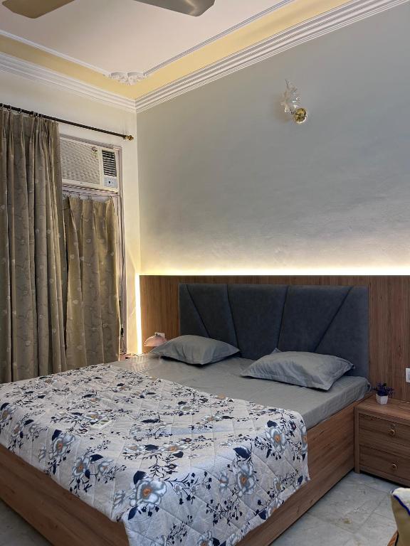a bedroom with a bed with a blue and white comforter at Stay Royal Imperial in Jammu