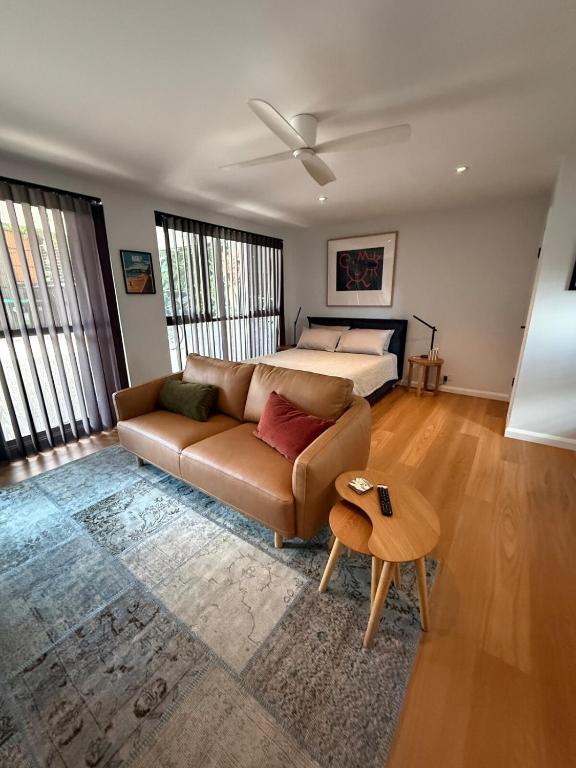a living room with a couch and a bed at Modern Studio in Sydney