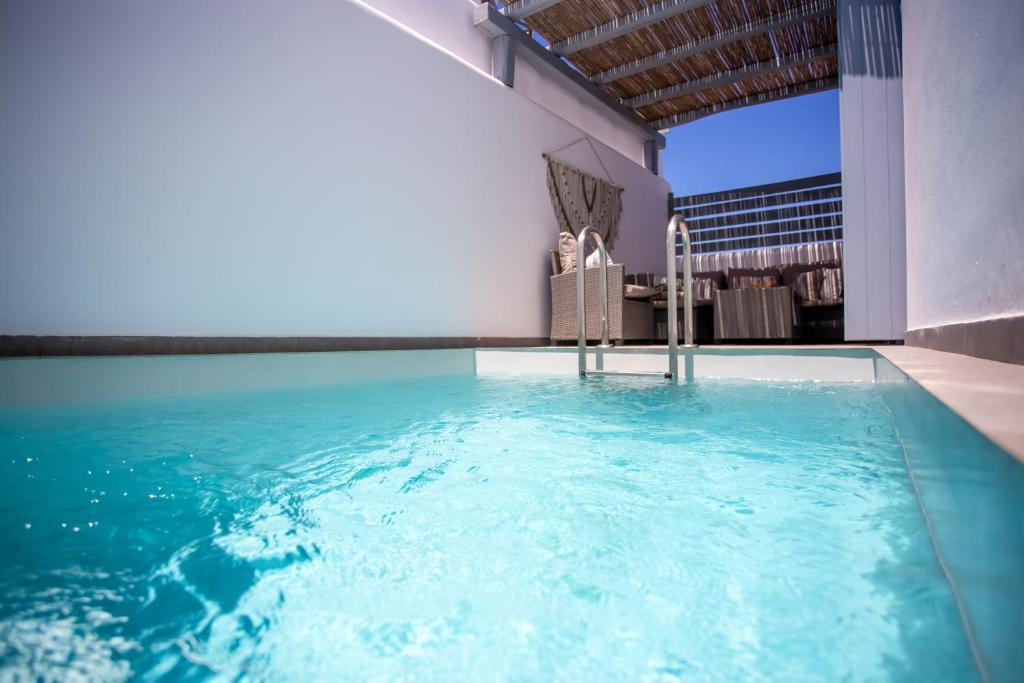 a swimming pool in the middle of a building at Whisper Villa Mykonos in Ano Mera