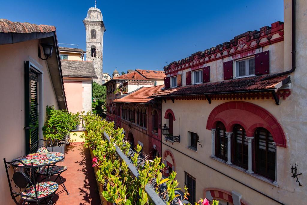 an alley with buildings and a clock tower in the background at Palazzina Storica al Mare, Rapallo in Rapallo
