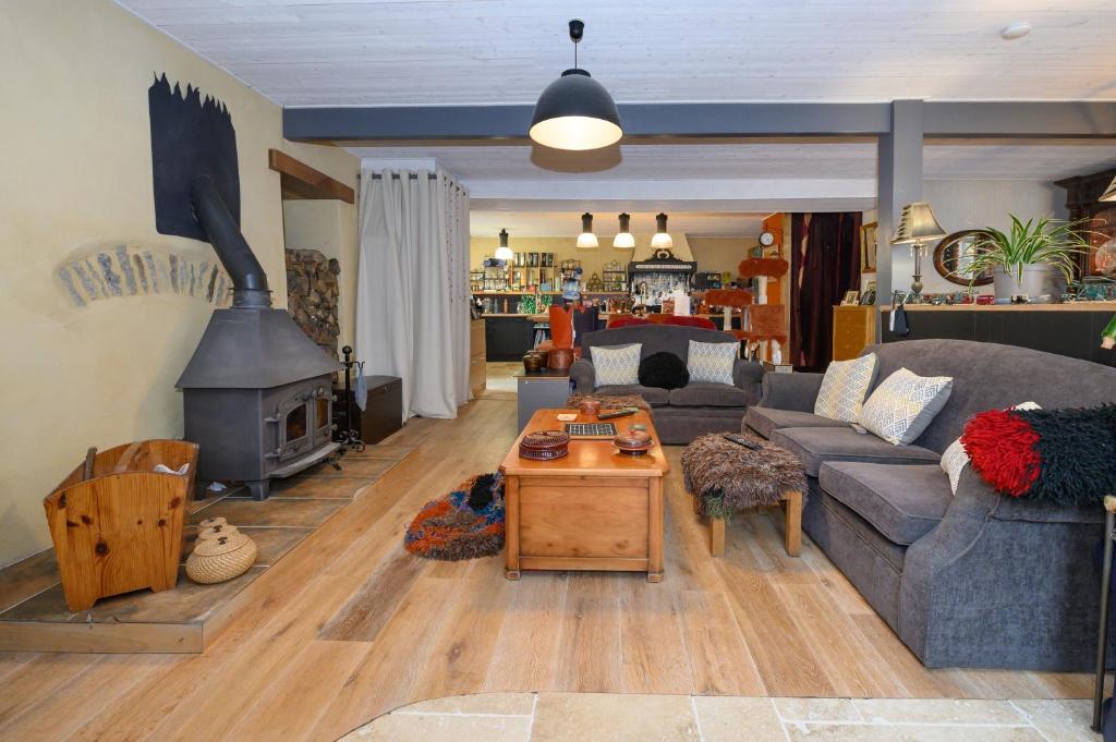 a living room with a couch and a fireplace at Le Rockin' Chair in Surzur