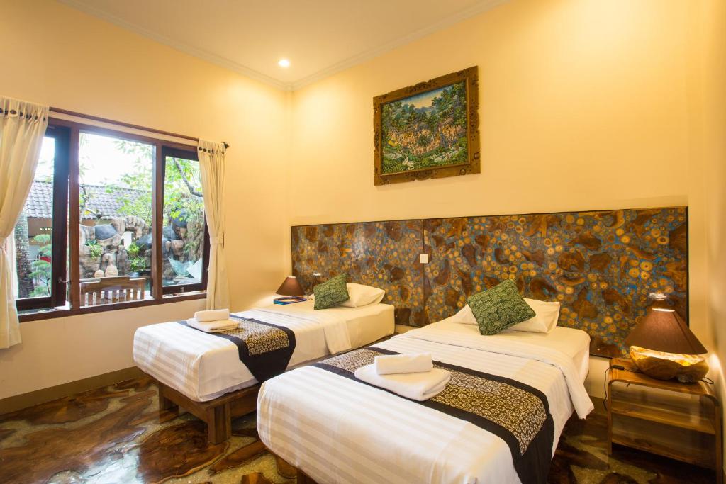 Postel nebo postele na pokoji v ubytování Bulan Bali Homestay