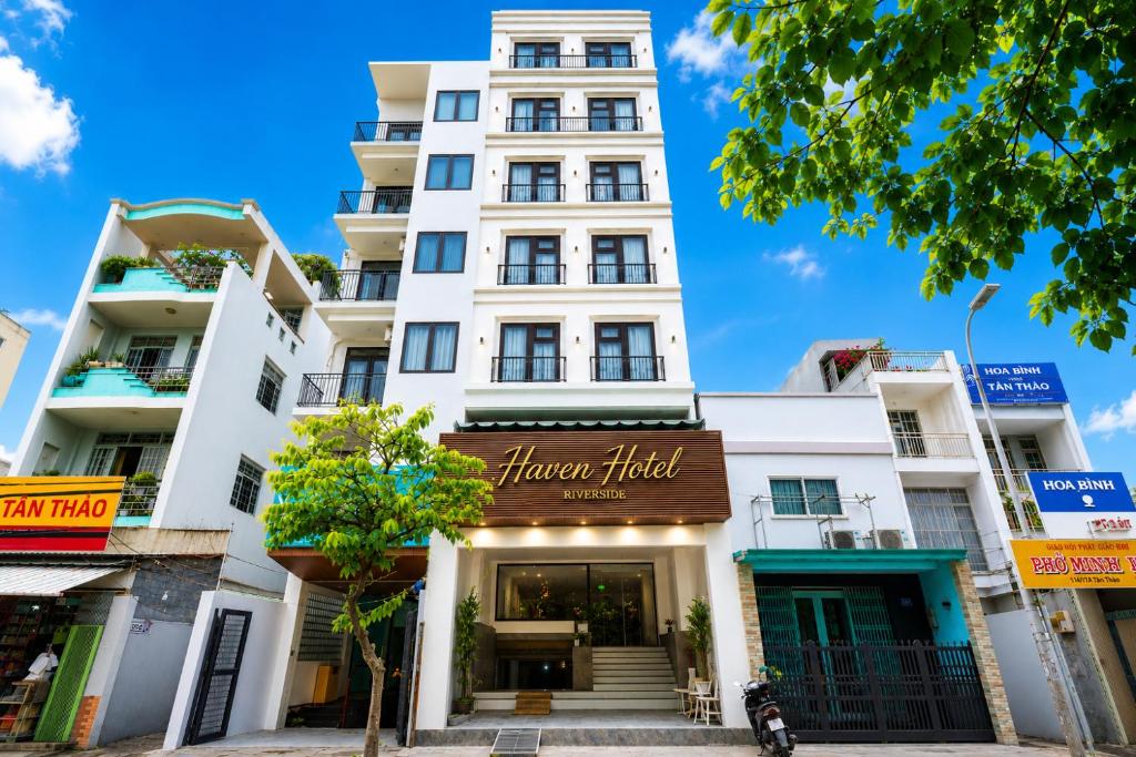 a white building with a sign that reads harvard hotel at Haven Hut Riverside Hotel in Ho Chi Minh City