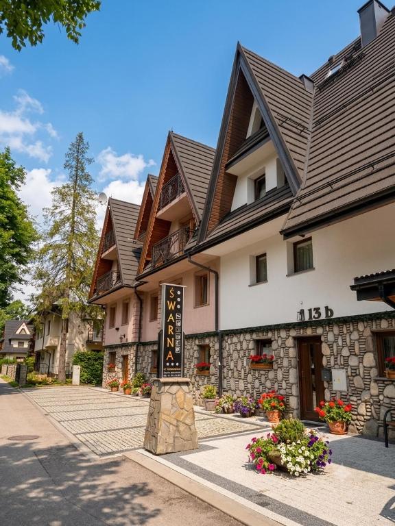 a building with a sign in front of it at Śwarna Wynajem Pokoi in Zakopane