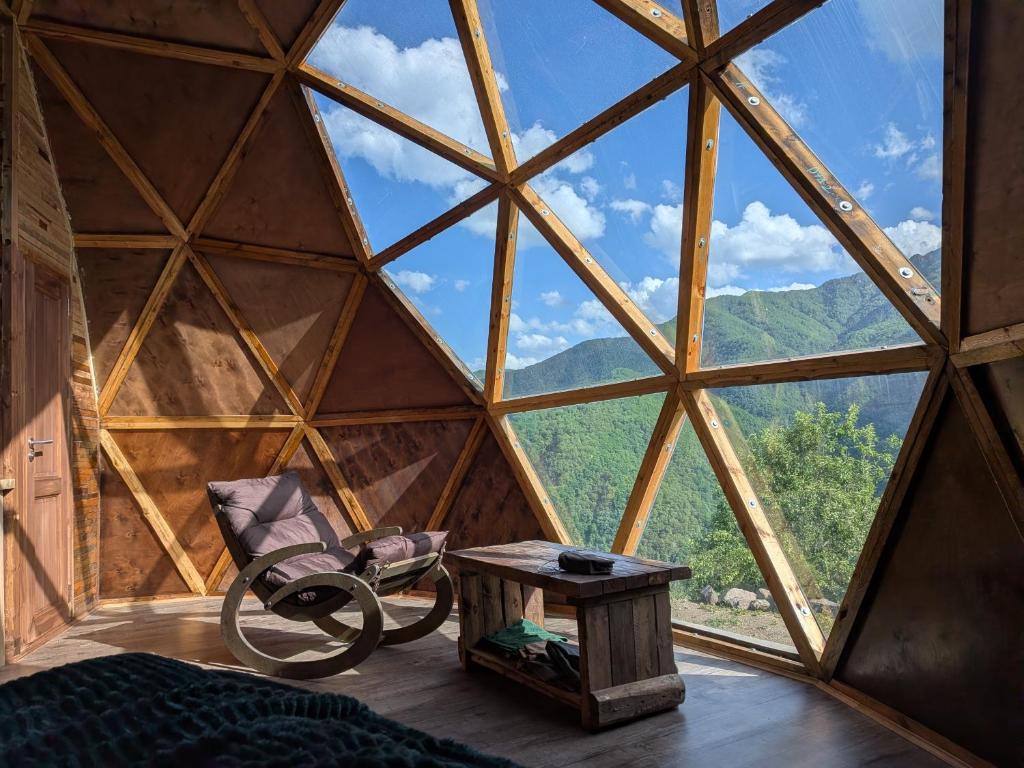 a room with a large window with a chair and a table at Knowledge Temple - Keni in Kapan