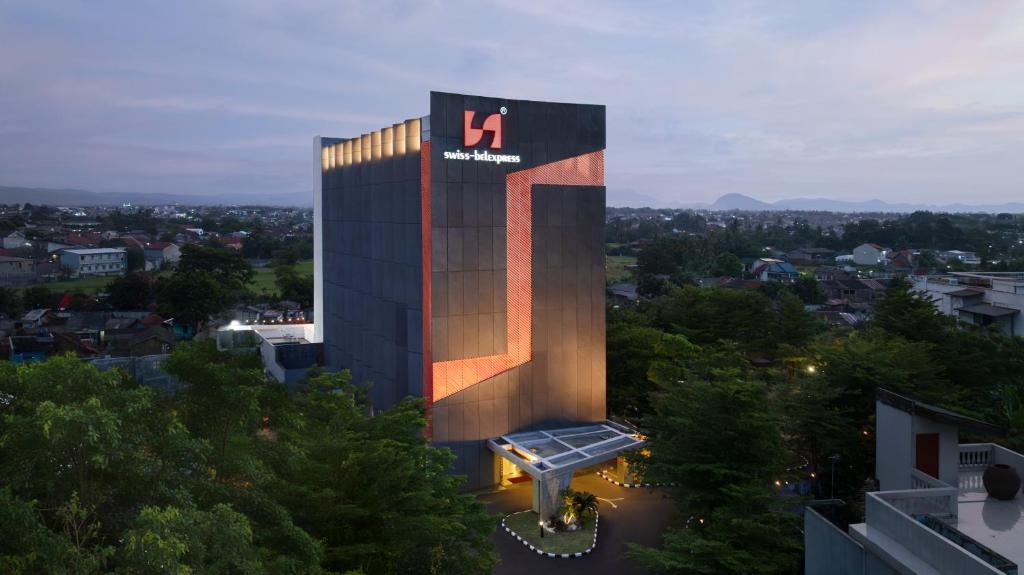 a tall building with a sign on the side of it at Swiss-Belexpress Cilegon in Cilegon