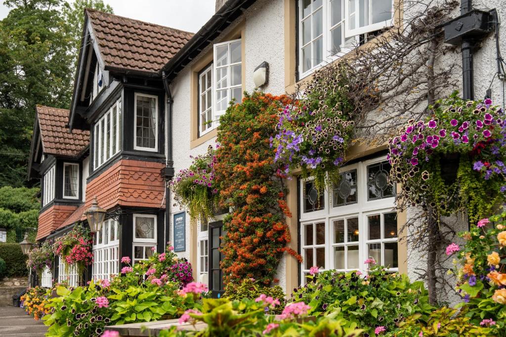 a row of houses with flowers on them at Scotsman's Pack Hotel in Hathersage
