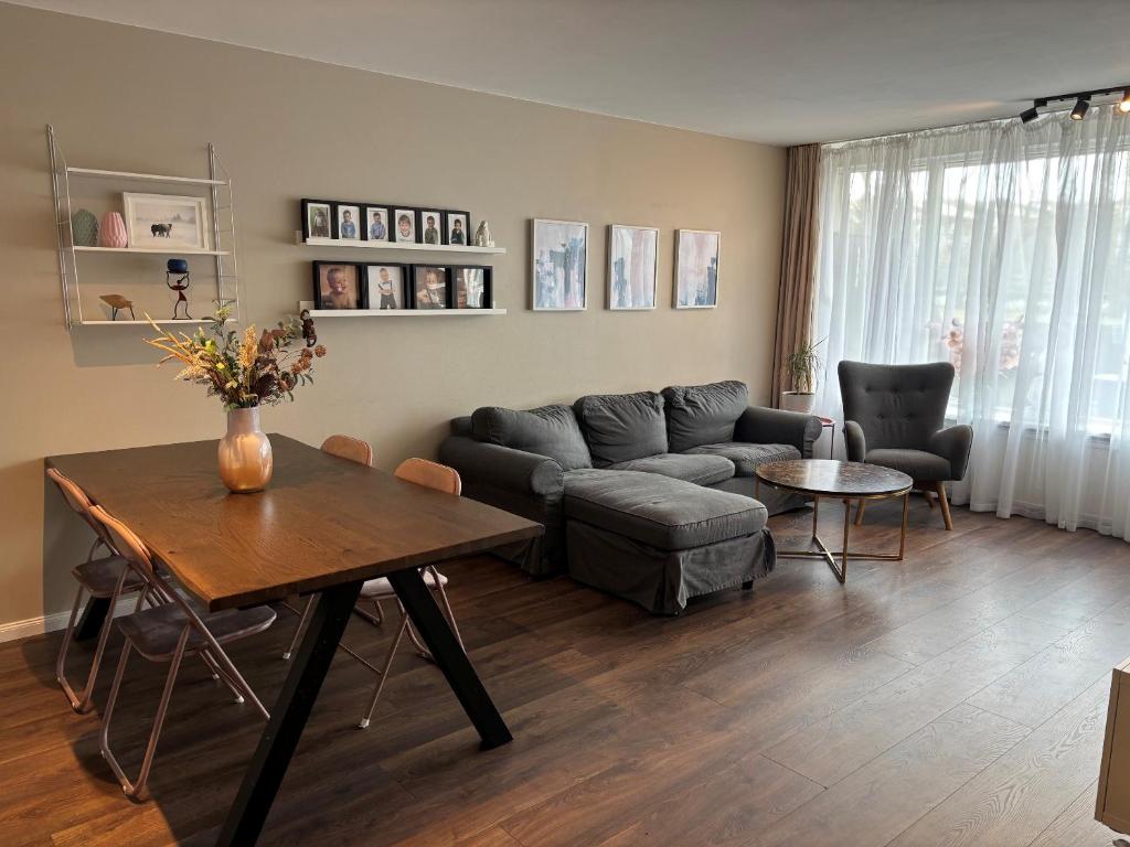 a living room with a couch and a table at Rofabær 45 in Reykjavík