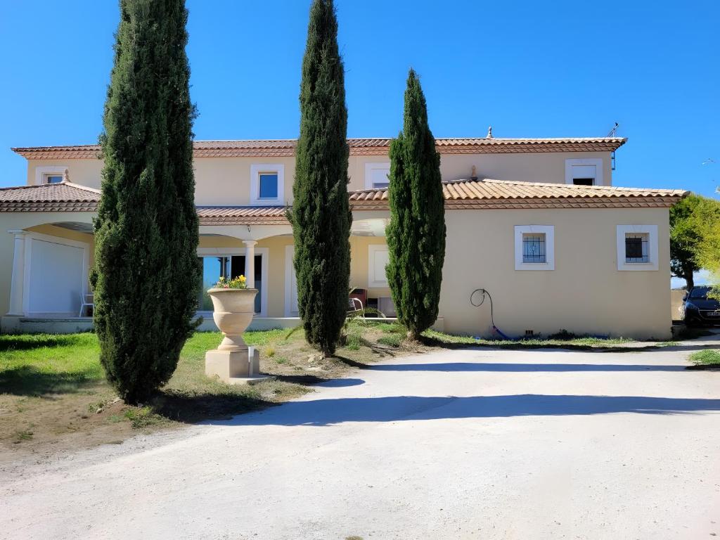 a house with trees in front of it at Césaria in Loupian