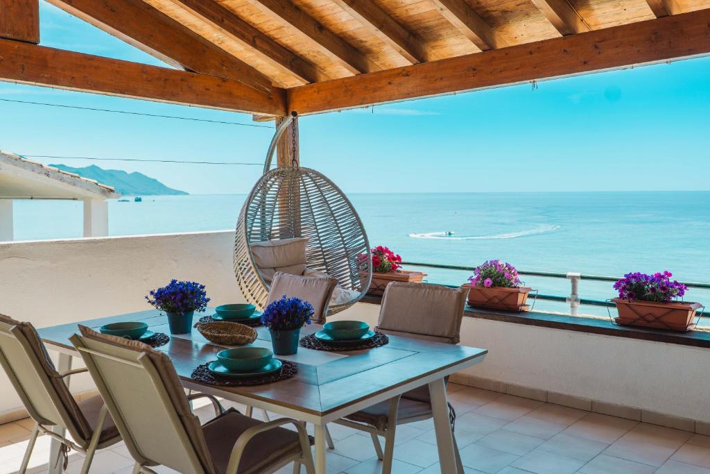 a table and chairs on a balcony with the ocean at Corfu Glyfada Beach Apartment 91 in Glyfada