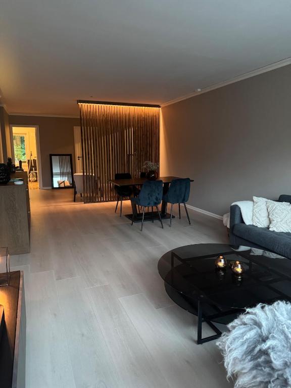 a living room with a couch and a table at Spacious apartment with 3 Bedrooms & balcony in Voss in Vossevangen