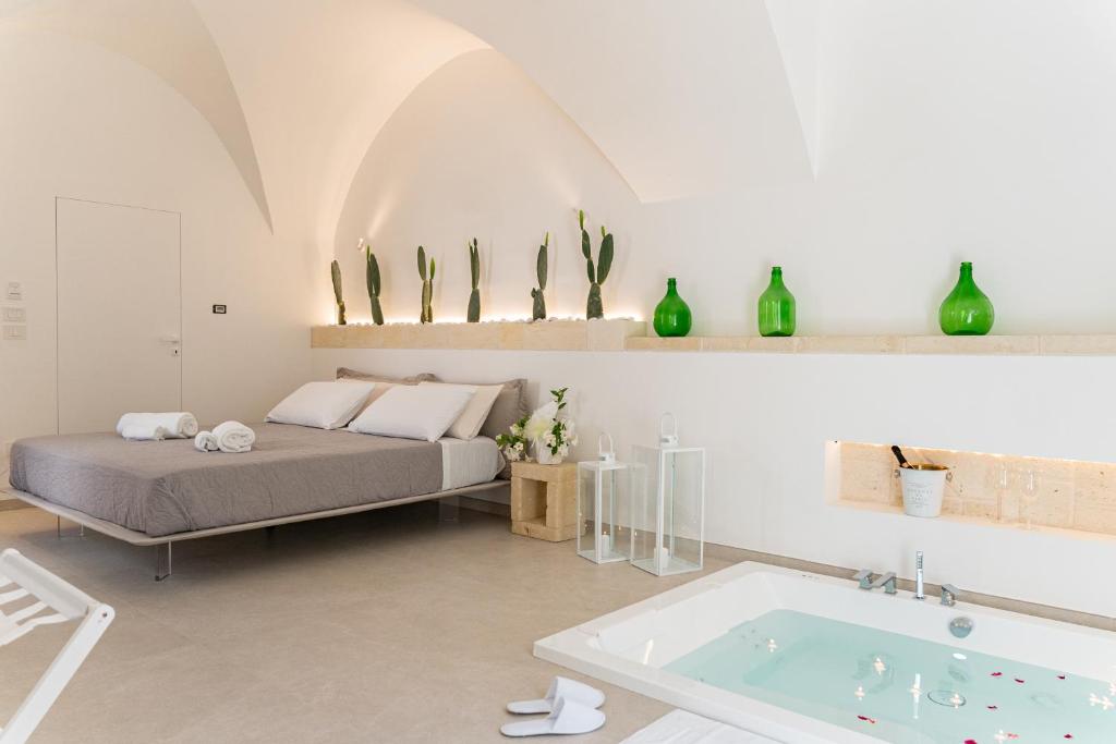 a bedroom with a bed and a bath tub at "Corte Tedesco" - Apulian Luxury Suites in Brindisi