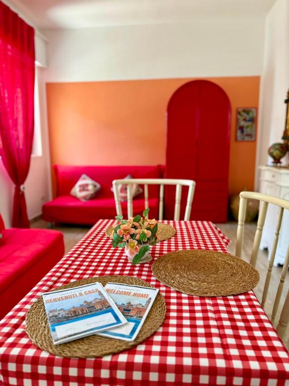 a table with a red and white checkered table cloth at Violahouse in Bari