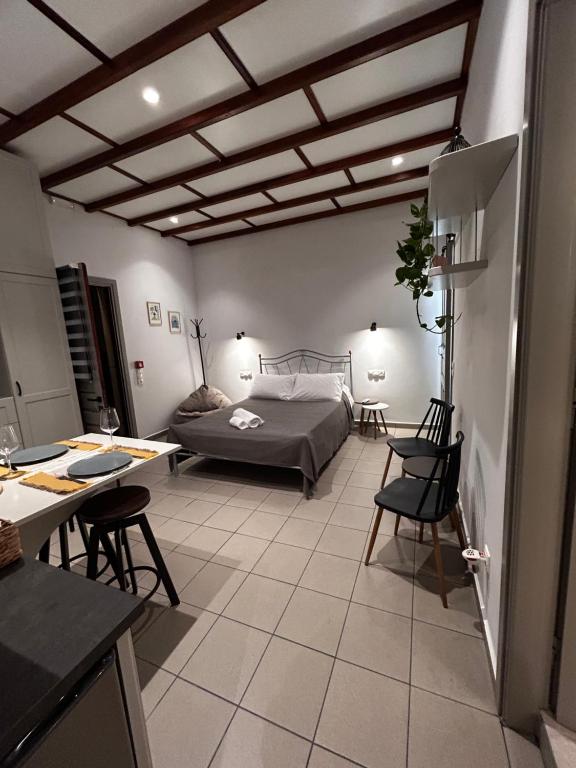 a bedroom with a bed and a table and chairs at Mezzo Patmos Apartments in Patmos