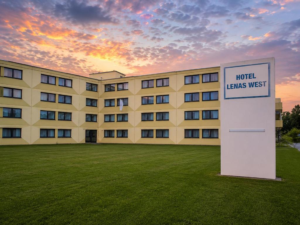 a large building with a sign in front of it at Lenas West Hotel in Vienna