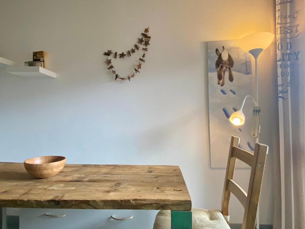 a dining room with a wooden table on a wall at Bright and silent studio in Bardonecchia centre in Bardonecchia