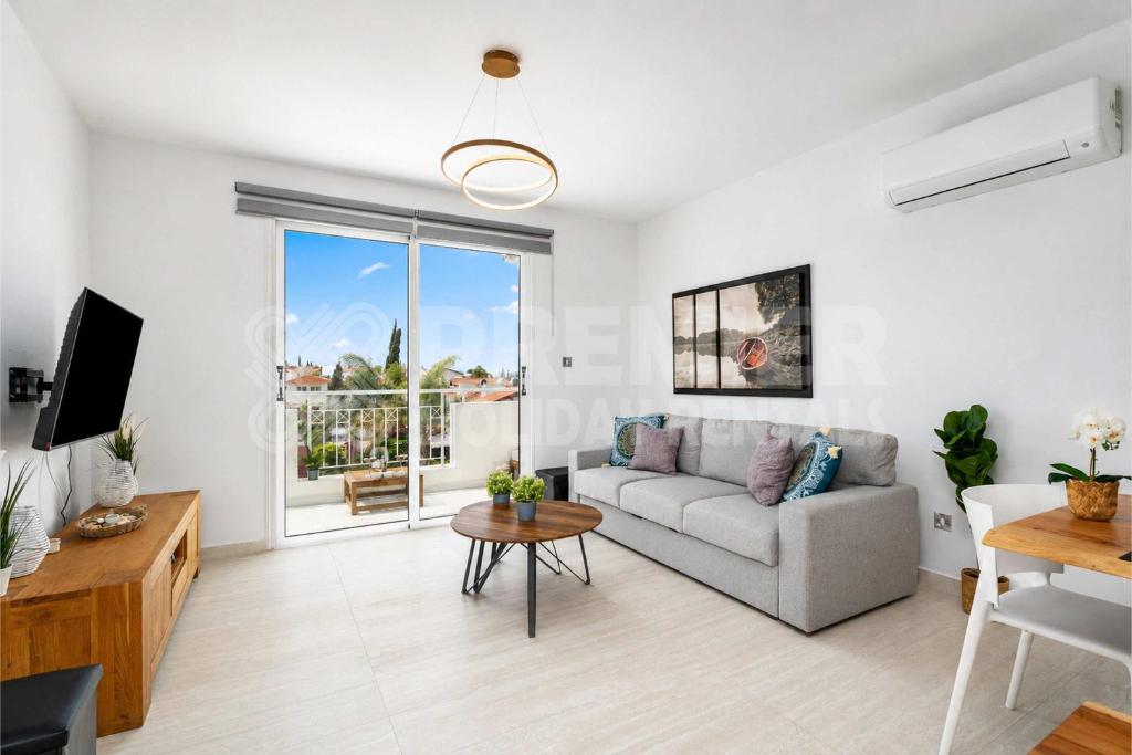 a living room with a couch and a table at Apartment El Breeze in Paralimni