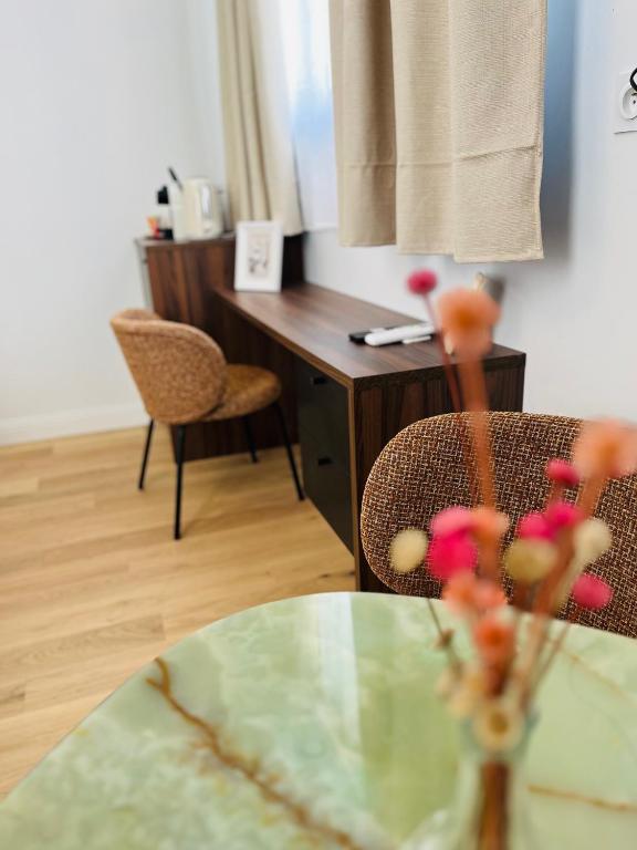 a room with a table and chairs and a desk at La Maison Kerguelen - Suite in Quimper