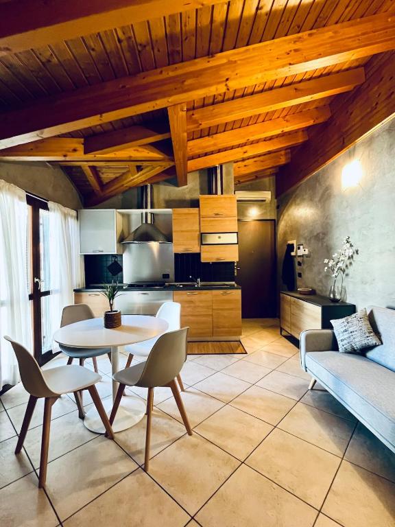 a kitchen and living room with a table and chairs at BEddy & Breakfast - Station Loft in Seregno