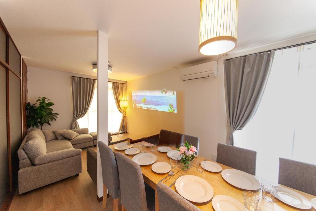 a dining room with a table with chairs and a couch at Kokura Family House, 10 Min to Station, 2 Parking, 4 Bed Room in Kitakyushu