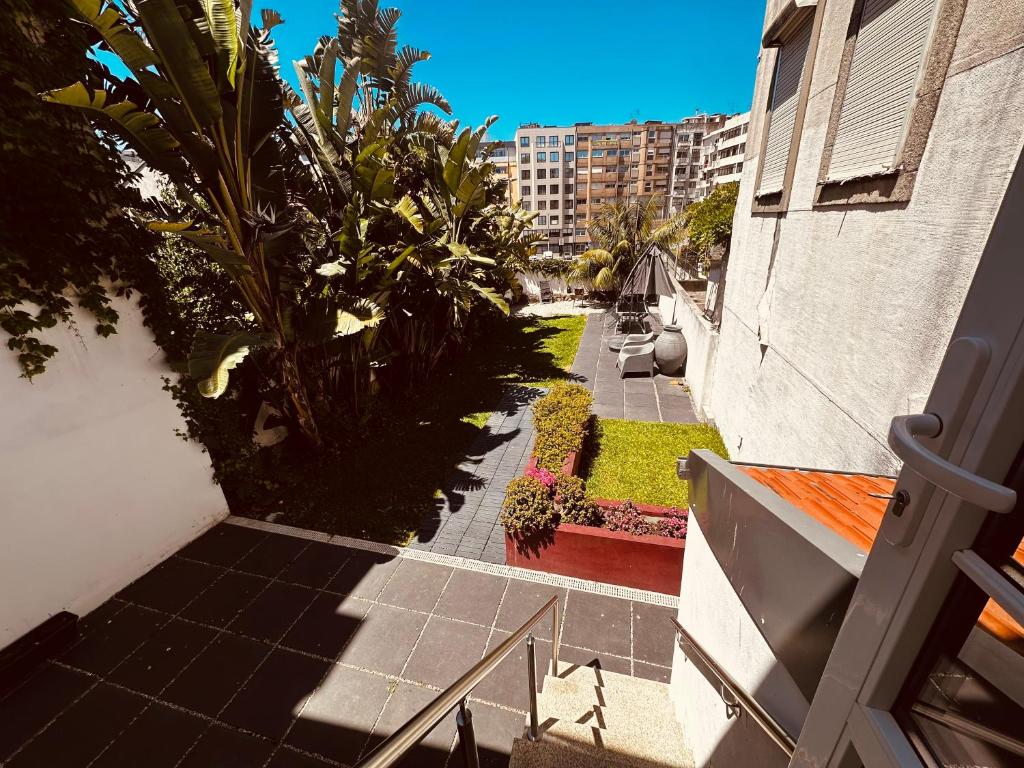an overhead view of a sidewalk with plants and a building at Casa Jardim in Porto