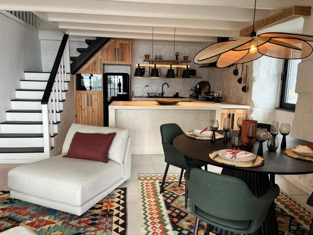 a kitchen and dining room with a dining table and a stairway at Casa do Encanto in Terra Alta