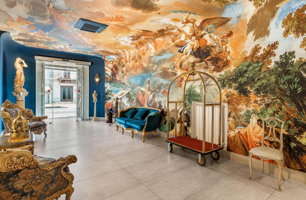 a room with a large painting on the wall at Hotel Regina in Caserta