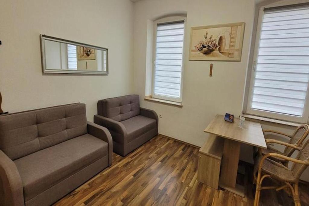 a living room with a couch and a table at Privileg - NewTime in Viersen