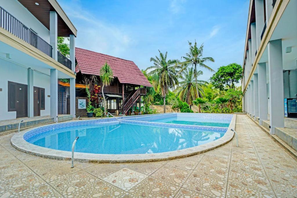a swimming pool in the middle of a house at Collection O Bwalk Hotel Malang in Malang