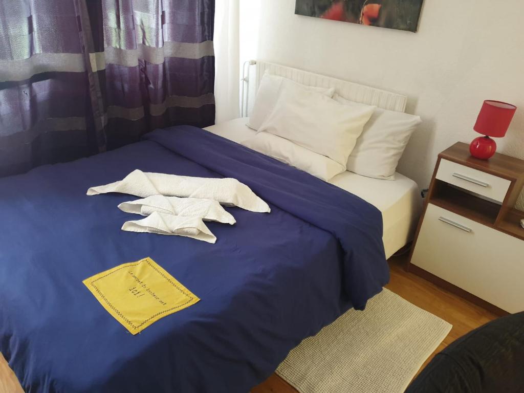 a bedroom with a bed with two towels on it at Cozy Private Room -5 mins from CERN -Shared Apartment in Saint-Genis-Pouilly