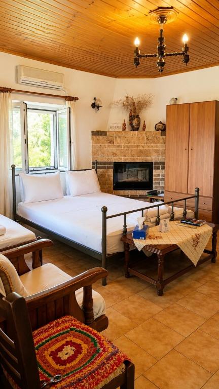 a bedroom with a large bed and a fireplace at Grapes and Roses 2 in Igoumenitsa