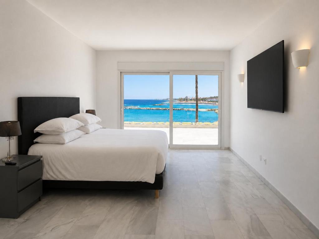 a bedroom with a bed and a view of the ocean at B51 Executive Flats Marbella in Marbella