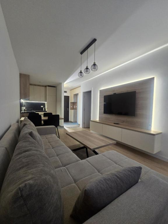 a living room with a couch and a flat screen tv at CityLux L in Doboj