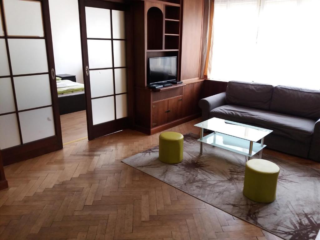 a living room with a couch and a table at Apartments Tronicek in Prague