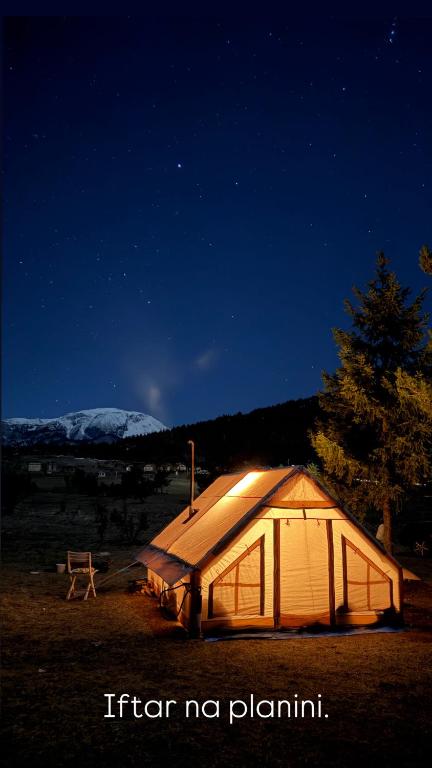 a tent in the middle of a field at night at Bosnian Nature Glamping in SJJ
