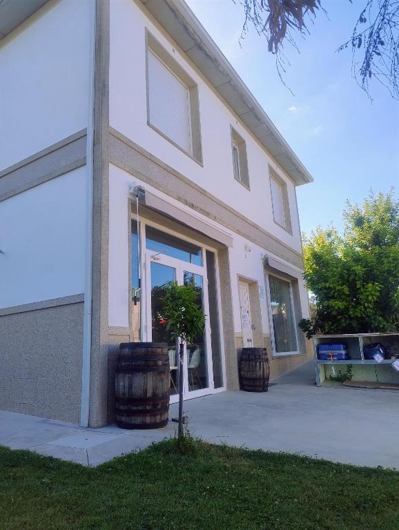 a building with two large barrels in front of it at Calm Stay in Teo