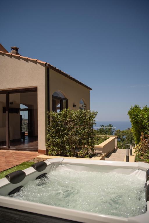 a hot tub in the backyard of a house at Breathtaking Sea Views & Jacuzzi in Cefalù in Cefalù