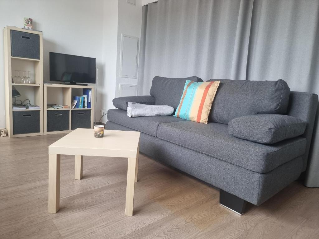 a living room with a couch and a table at Apartment am Apfelgarten in Schwarmstedt