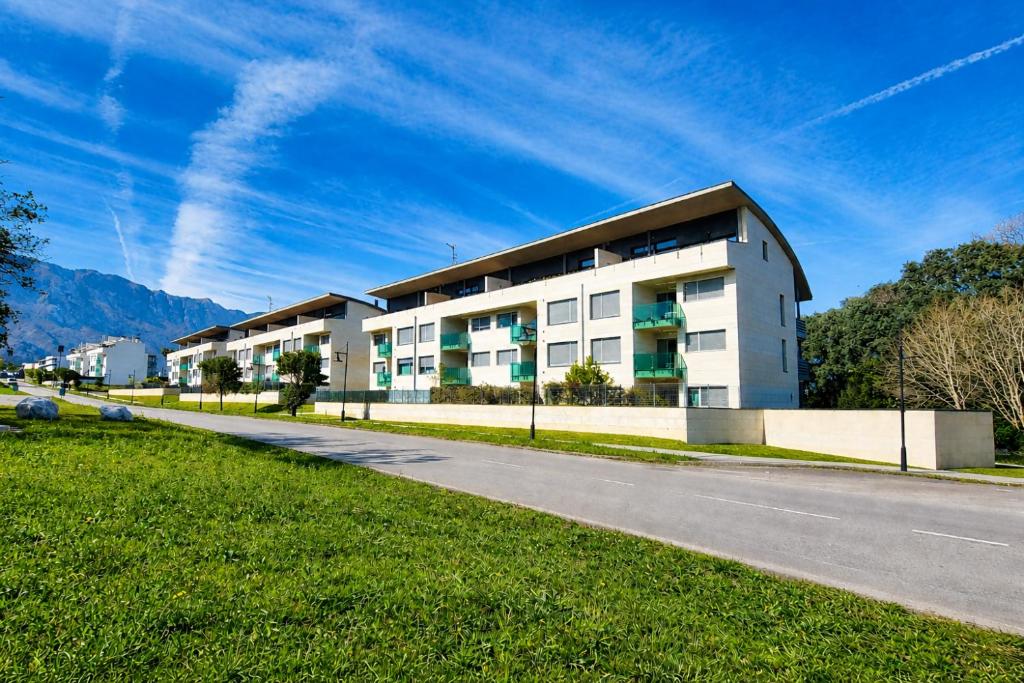 a building on the side of a road at El Arcin - Piscina, terraza y parking en Llanes in Llanes