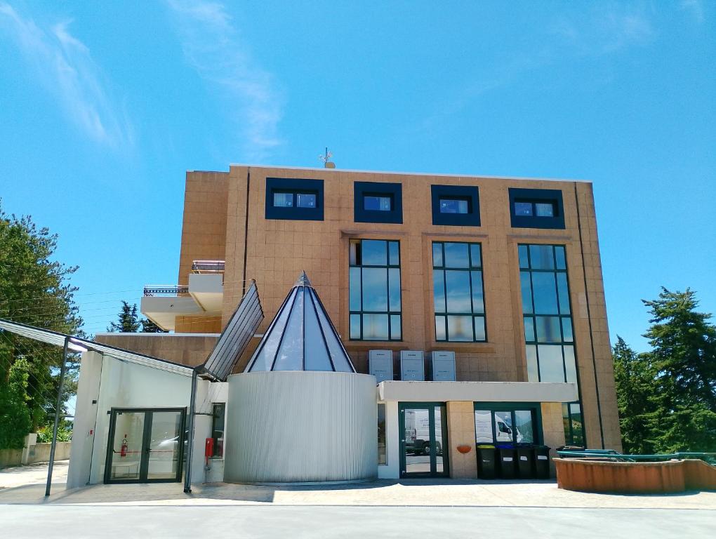 a large brick building with a blue roof at Viva Campus di GM Industries srl in Ferrazzano
