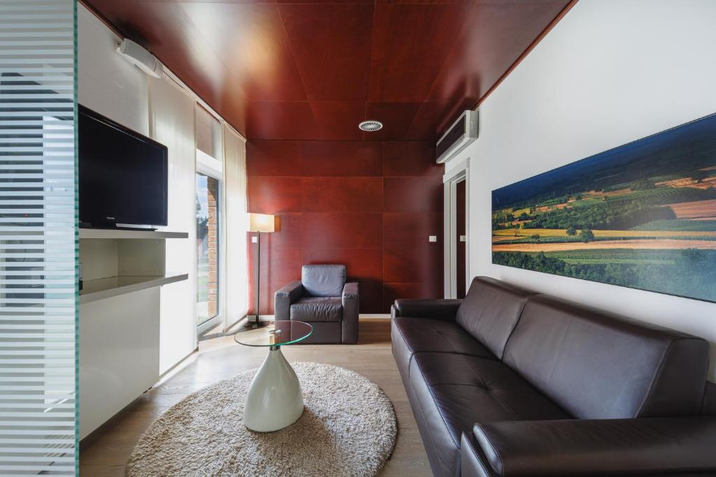 a living room with a couch and a tv at Ladanjsko Imanje Principovac in Ilok
